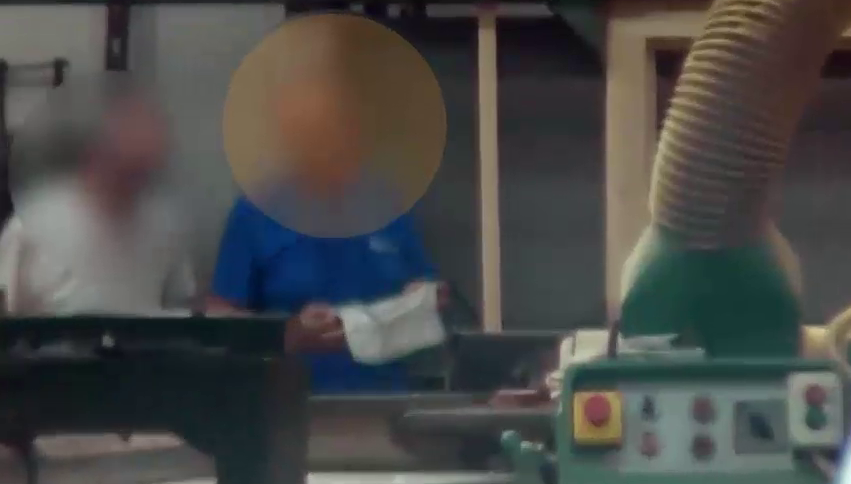 Surveillance still of a subject in a workshop in Northern Italy